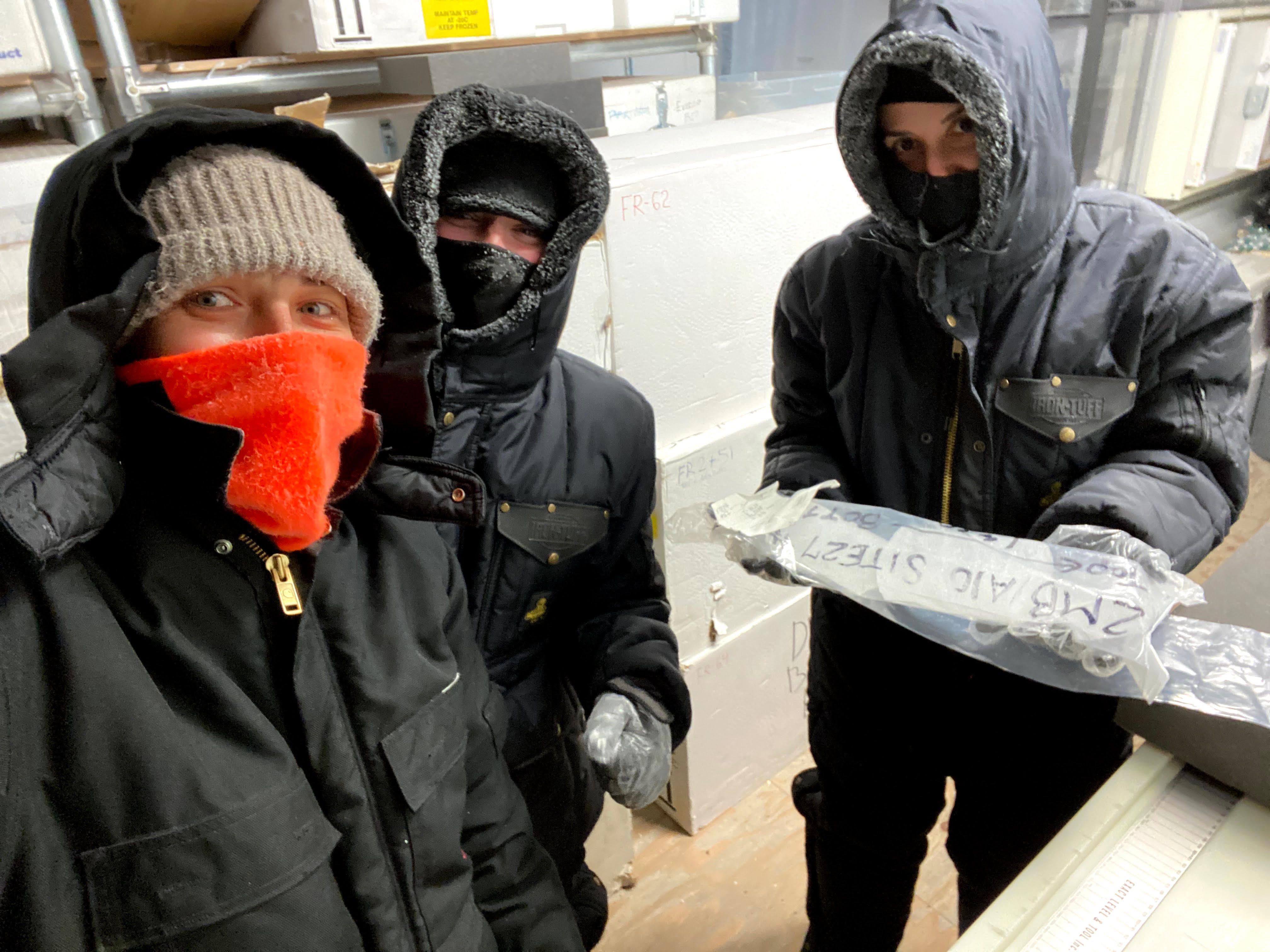 UMaine graduate students Lela Gadrani, Hanna Brooks, and Meredith Helmick work on ice cores in the freezer